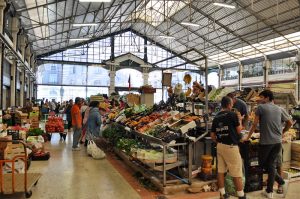 View of food stands in an indoor market with glass ceiling