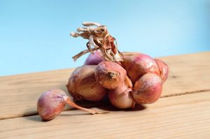Pile up onions on a wooden surface