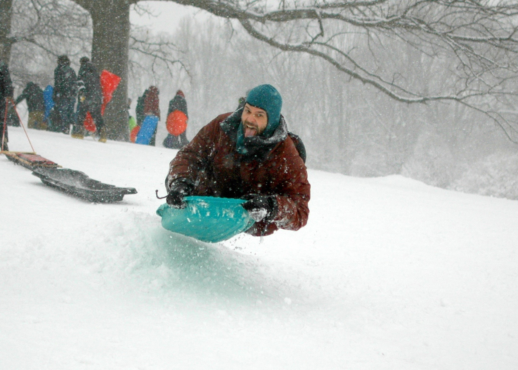 a man sledding down a hillside