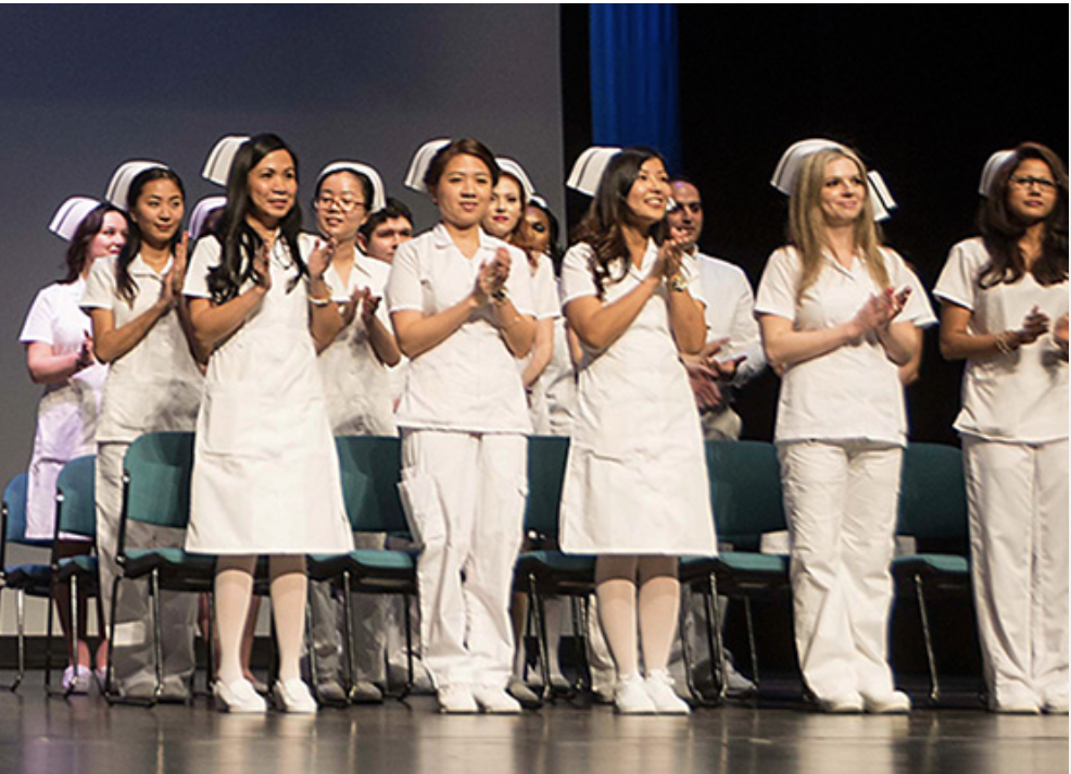 Group of students in nursing outfits at graduation.