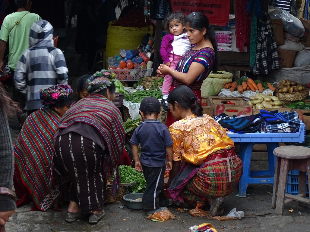 Women and children at a market in Guatemala.