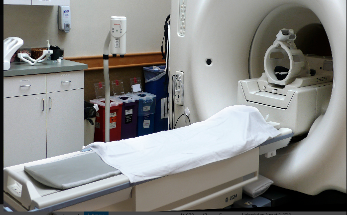 Photo of an MRI scanner - large white tube with bed