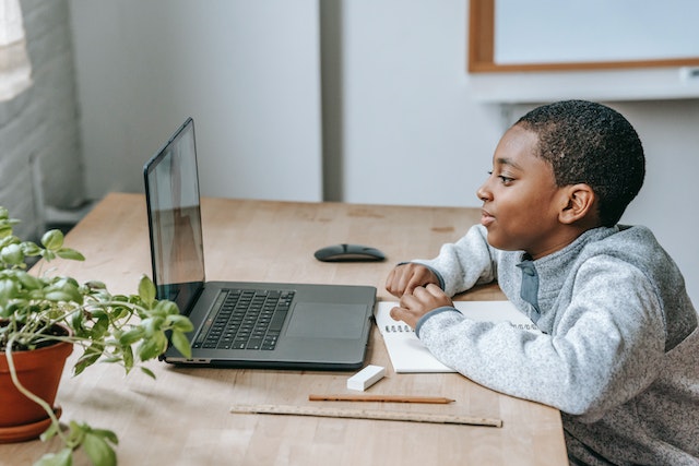 African American boy doing homework on computer