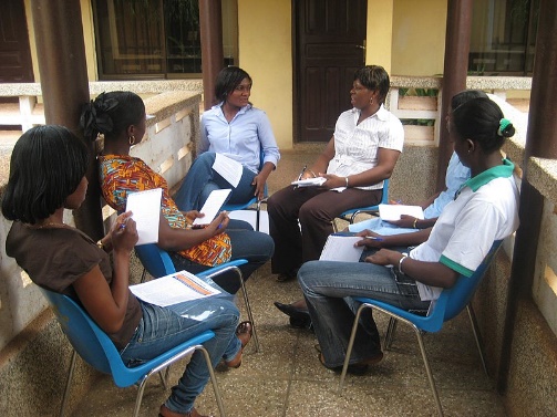 People sitting in a circle talking together in a focus group