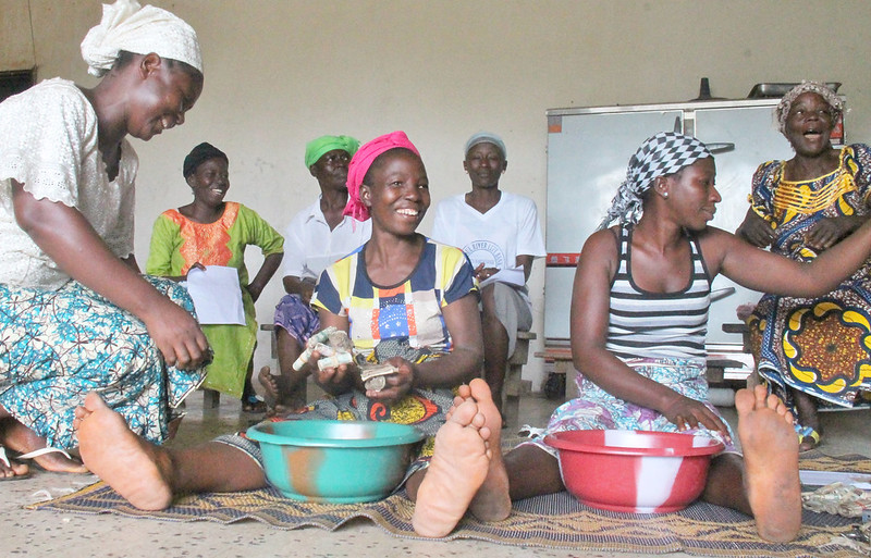 The women of Kweigbein Farmers Association, located in Bensonville, Liberia, meet after a nine month savings cycle to divide the shares of their Village Savings and Loan Association.