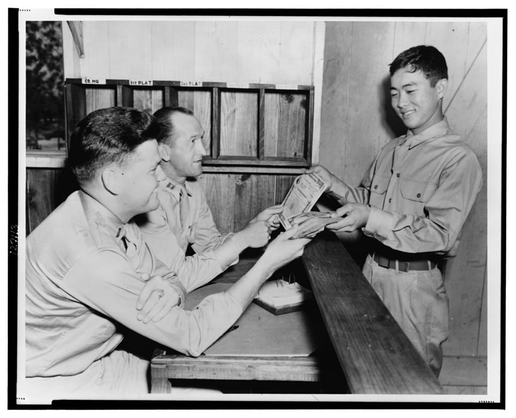 Japanese-American soldier buying U.S. war bonds