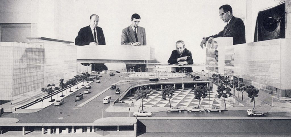 architectural model showing traffic flow, Sweden, with architects looking on.