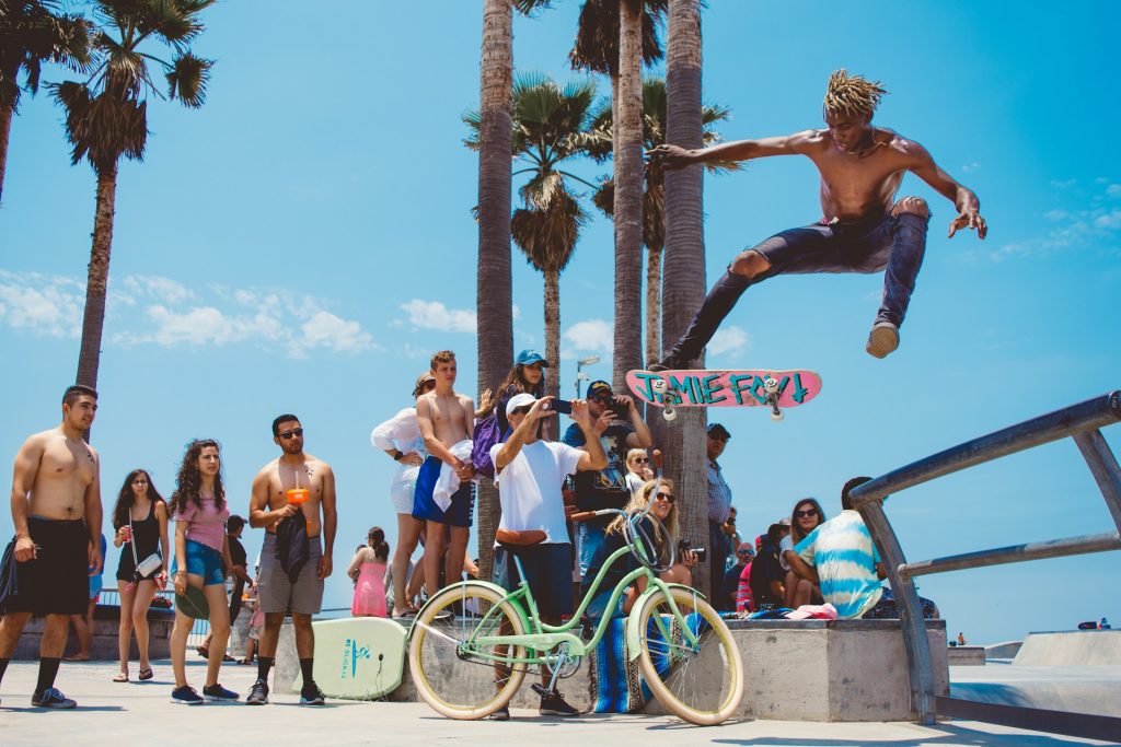 Skateboarder leaping with crowd watching