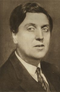 black-and-white portrait of a white man with pale eyes and thick dark hair