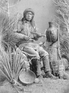 An Apache musician playing the “Apache fiddle”