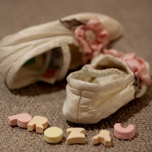 Picture of a pair of kids shoes with alphabet pills spelling the word "Prozac".