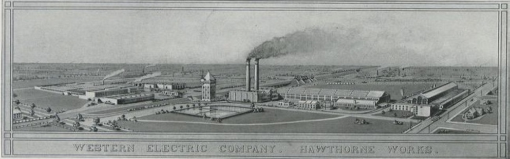 An image of a factory complex with two functioning smokestacks and a number of buildings is shown.