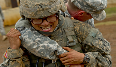 A photograph shows two soldiers physically fighting.