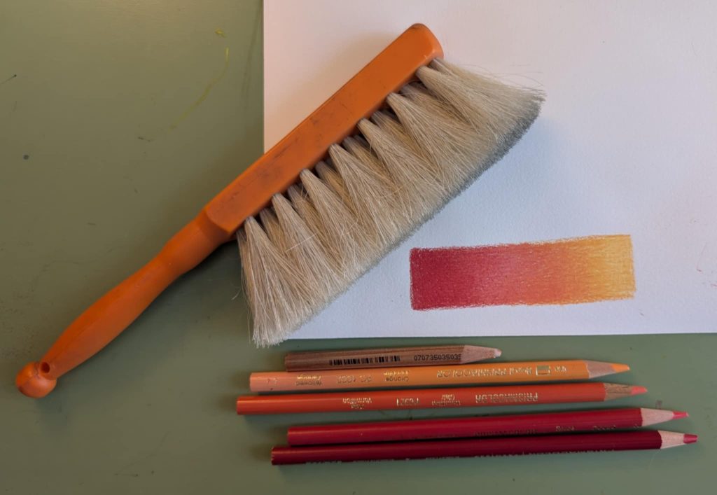 Four color gradient on hot press paper, showing the brush used to remove the dust and the colored pencils